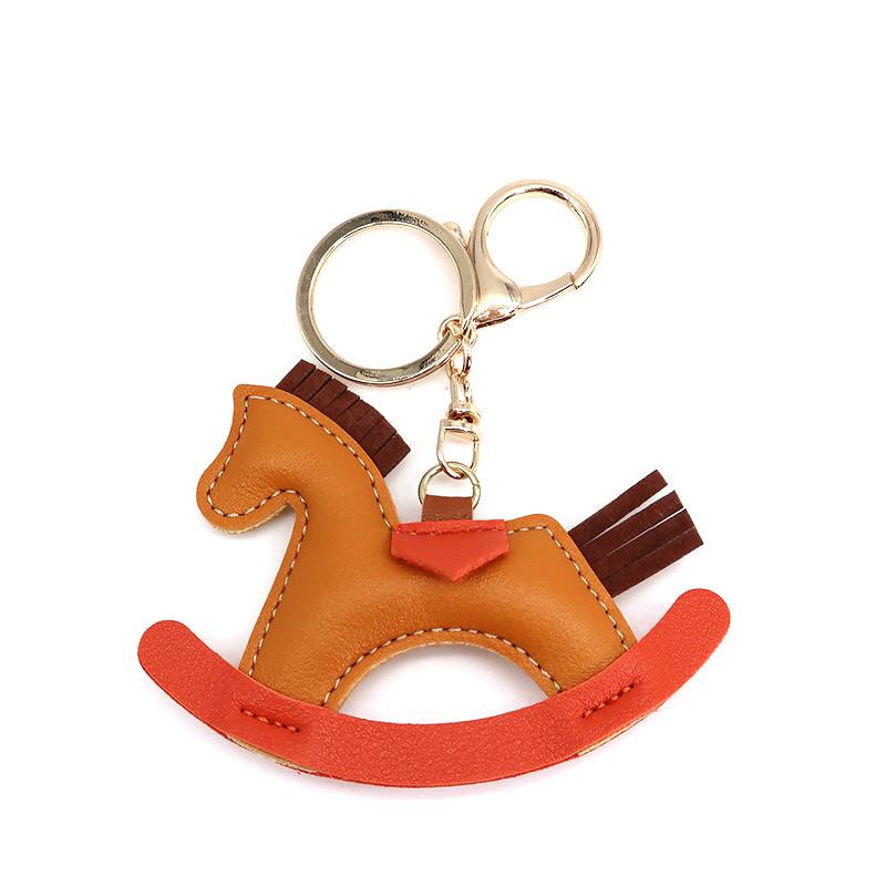Cartoon Rocking Horse Keychain: Creative PU Leather Pony Charm with Cotton Filling.