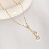 Copper-Plated Gold Four-Leaf Clover Tassel Pendant Necklace - Elegant, Minimalist, and Luxurious.