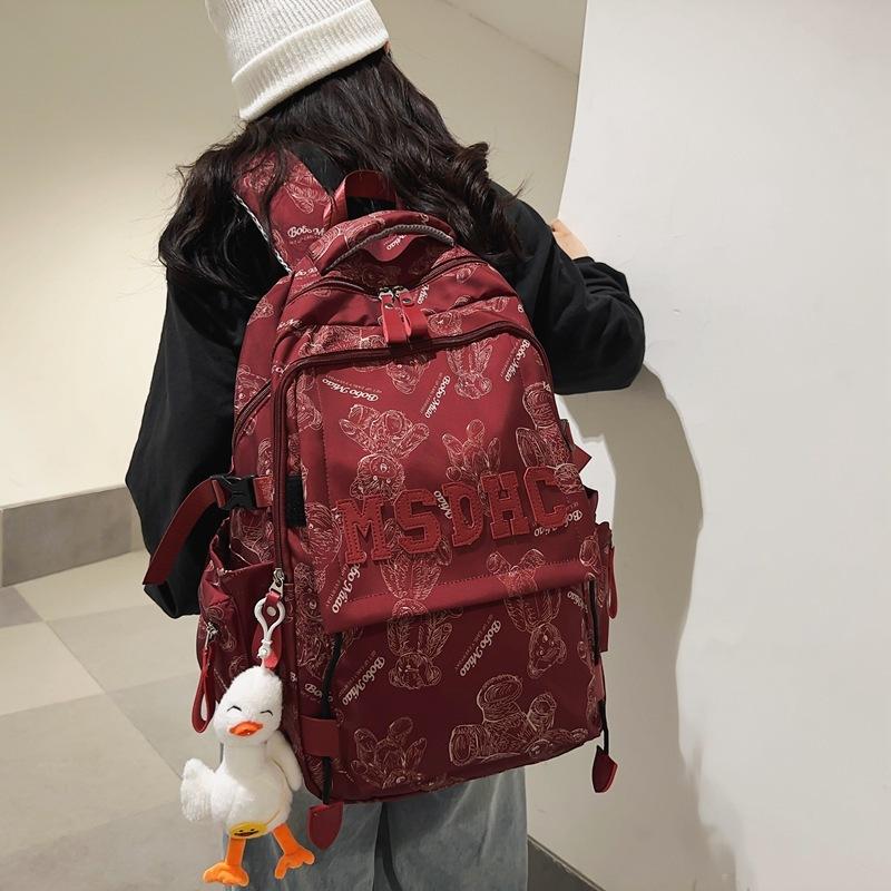 School bag for female junior high school students, simple and versatile printed bear niche design 2025 new college student computer backpack for men