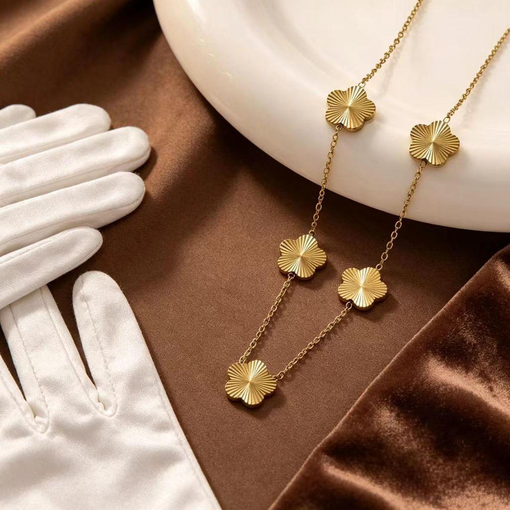 Gold-Plated Titanium Steel Four-Leaf Clover Jewelry Set: Necklace, Bracelet & Earrings for Women – Luxurious High-End Feel.
