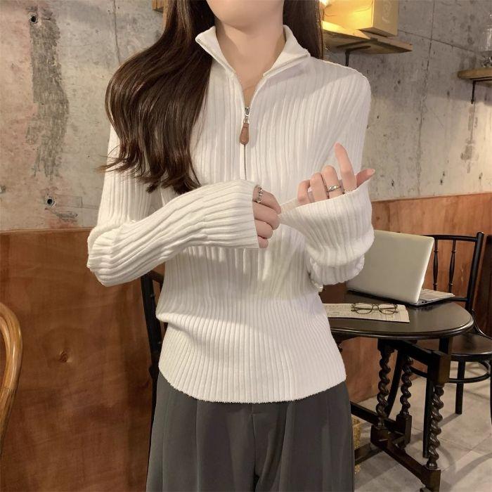 A Woman with A High-end Semi-high Collar with A Zipper and A Long-sleeved Knitted Sweater Underneath