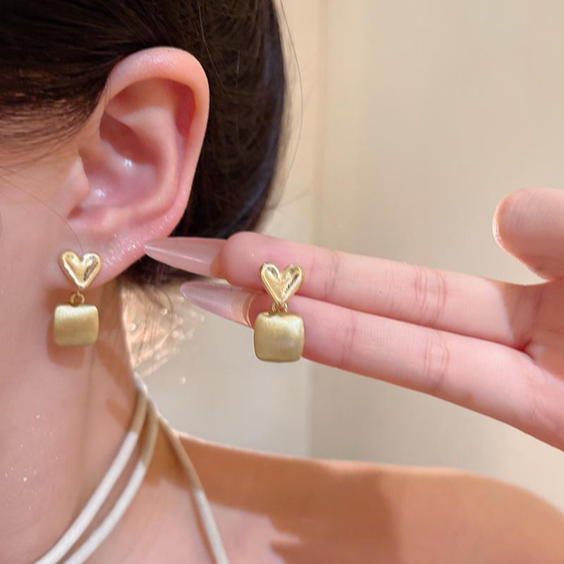 A pair of gold double love stud earrings for women s versatile glossy earrings, Hong Kong style earrings.