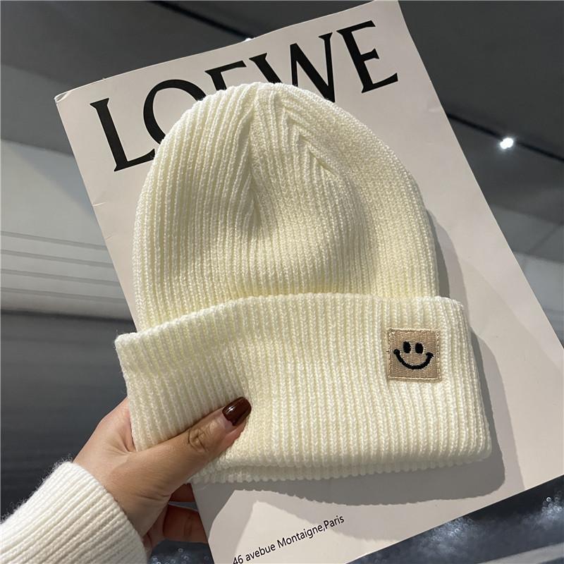 Cute smiley face label wool hat women's autumn and winter warm trend versatile ear protector black knitted hat men