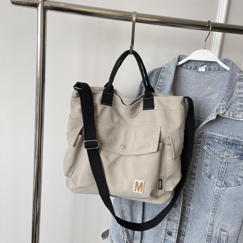 

Simple and fashionable large capacity commuter bag female college student handbag for class niche design one-shoulder crossbody bag сірий колір
