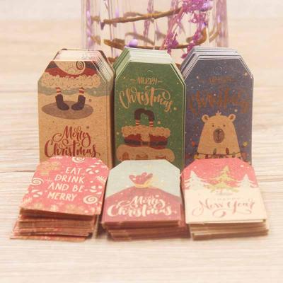 100 szt. Etykiety Wesołych Świąt 4x2cm Papier Kraftowa Kartka Etykieta na Prezent Etykiety do Zawieszenia DIY Dekoracja Pakowania Prezentów Kartka z Życzeniami