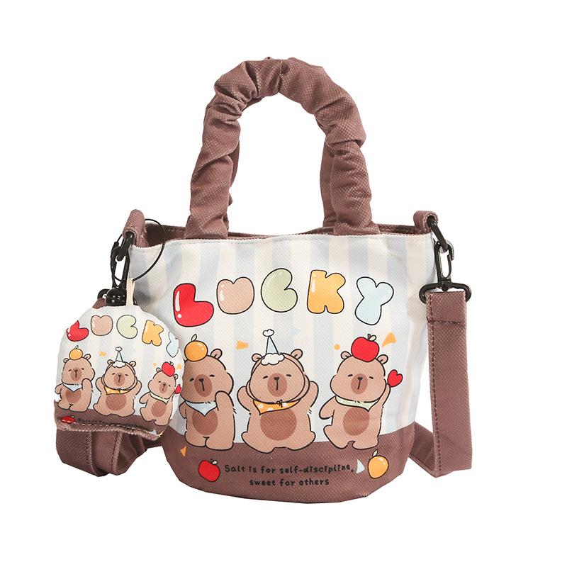 Elegant Women s Canvas Handbag with Pendant, Versatile Bucket Design, Single Shoulder, and Crossbody Style.
