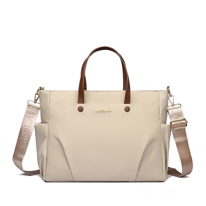 A Laptop Bag, A Lady Carrying A Business Briefcase and Slung A Commuter Tote Bag Across Her Shoulder