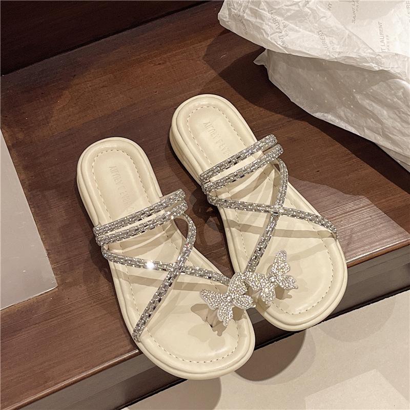 Beautiful flat-bottomed slippers for women's summer wear 2025 new butterfly rhinestones with skirts and two sandals.