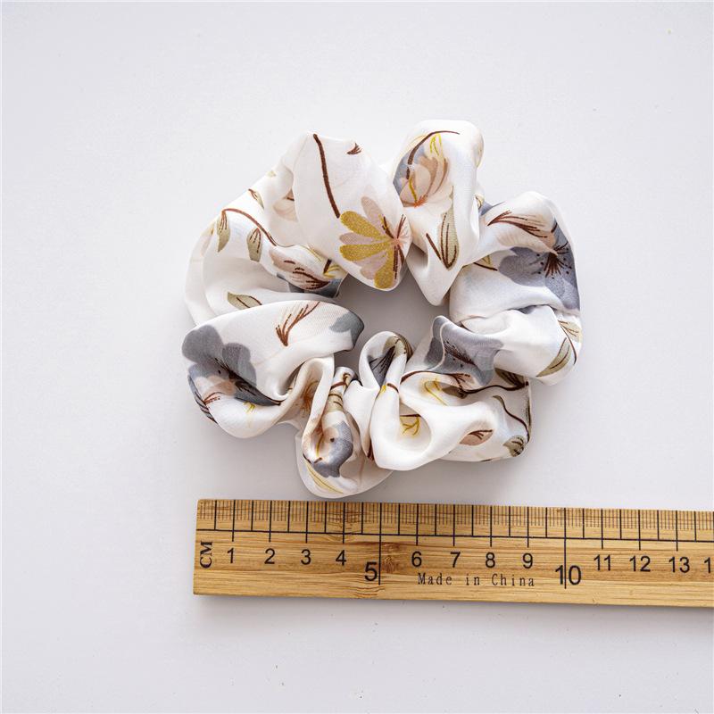 French-style smooth satin scrunchie with floral pattern, versatile elastic hair tie for women, popular on Instagram