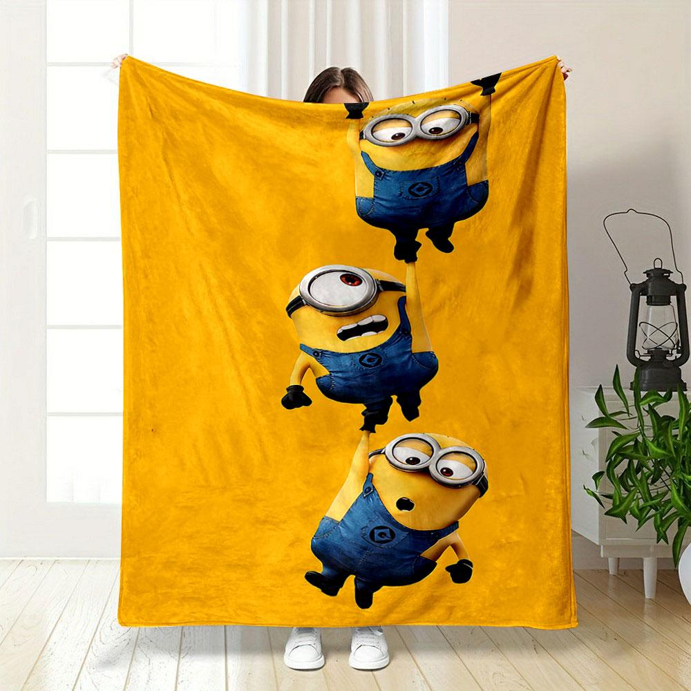 Three Minions in blue overalls hanging from each other on a yellow background. for all seasons blanket lunch break throw gift
