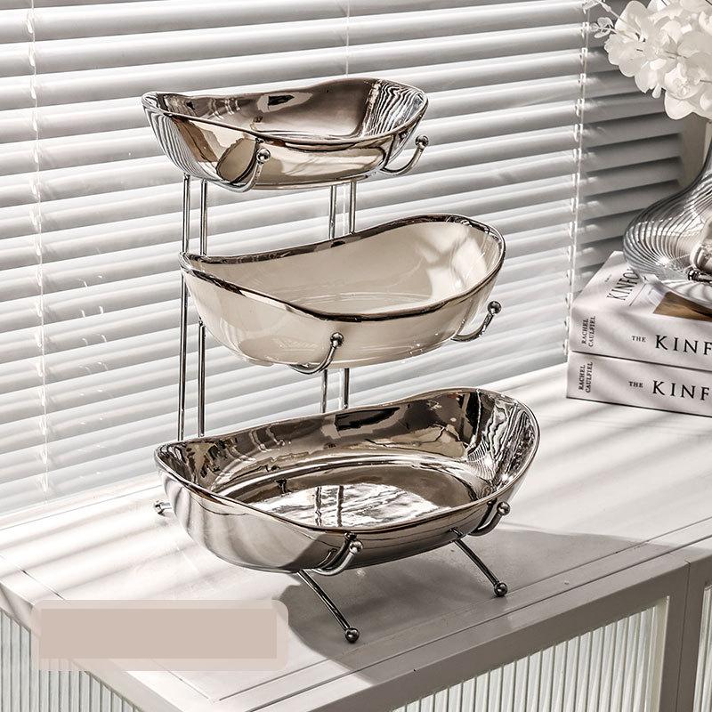 

Простая тарелка с фруктами Многослойная Легкая Роскошная керамическая тарелка с фруктами Высокий внешний вид Хороший продукт Тарелка с сухими фруктами Гальваническое покрытие Конфетная тарелка Yuanbao