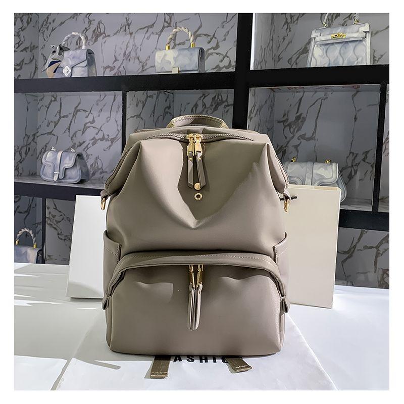 

Hong Kong Genuine Large Capacity Women s Backpack 2025 New Arrival Tide Minimalist Light Travel Bag Computer Business Backpack Grey small size M(Can put 13.5 inch computer)