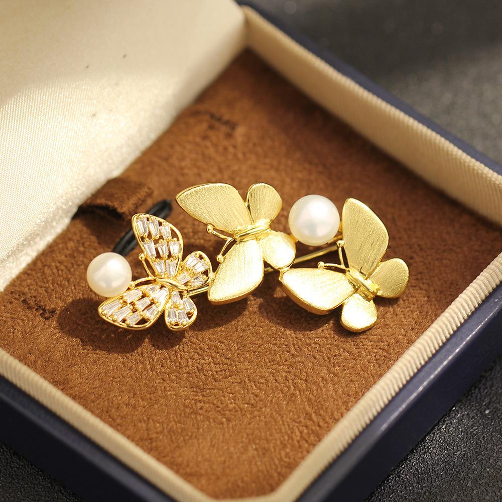 Light luxury, high-end sense, three butterflies, gold brushed craft brooch, slightly inlaid with zircon, freshwater pearl, insect pin, female.