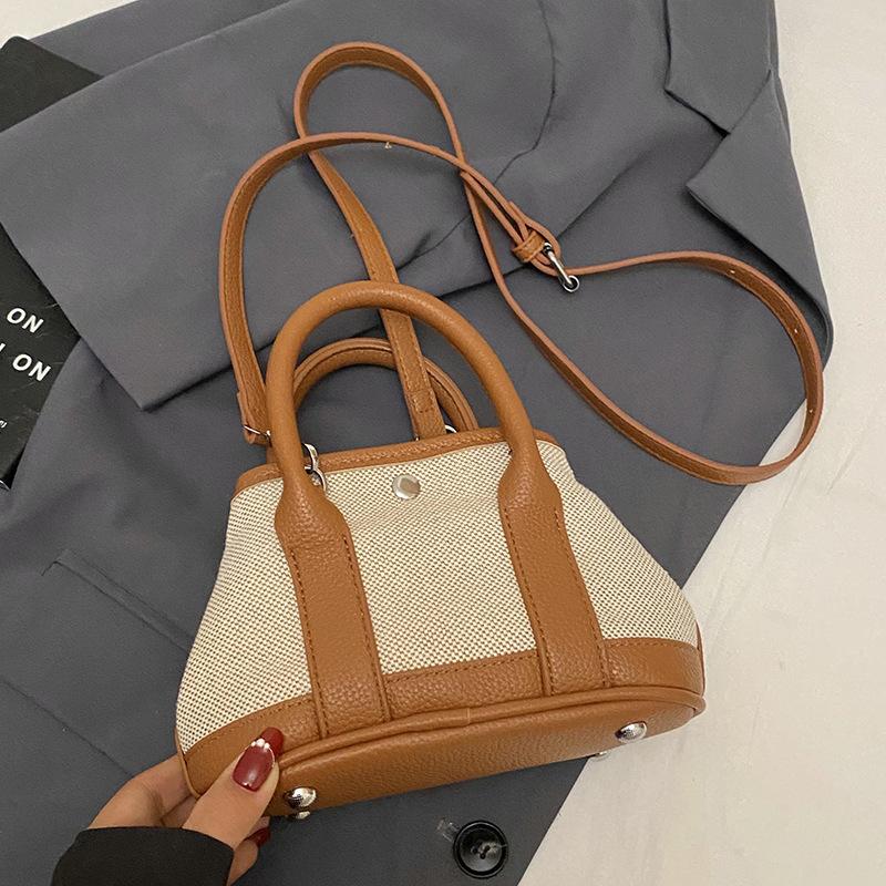 

Корейская версия повседневной нишевой контрастной цветной拼接 портативной сумки-ведра модная универсальная темпераментная повседневная сумка-мессенджер для поездок на работу женская