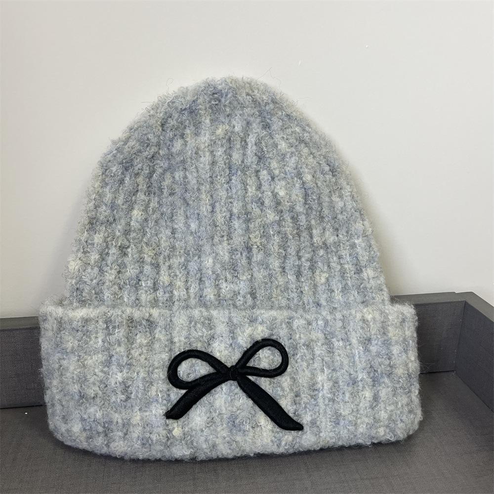 Hat women's autumn and winter wool hat new cute bow versatile cold hat ear protection warm knitted hat tide