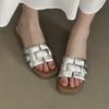 Wearing open toed woven beach sandals with a single low heel for outdoor wear