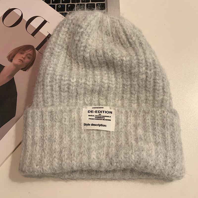 Chapeau de laine coréen doux et mignon à grosse tête Automne et hiver Décontracté Polyvalent Chapeau de tête Coupe-vent Oreilles chaudes Chapeau tricoté