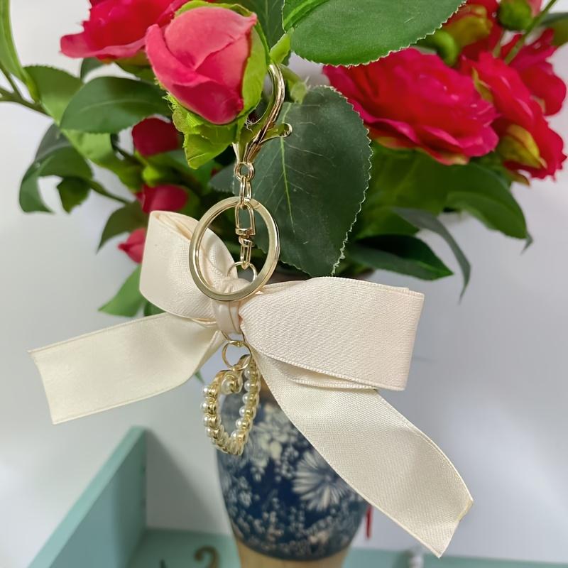 Elegant Pearl Strand Bow Keychain with Heart Charm, Octagonal Shape, Floating Fun-Themed Accessory, with Split Ring Closure for Handbags and Car Keys