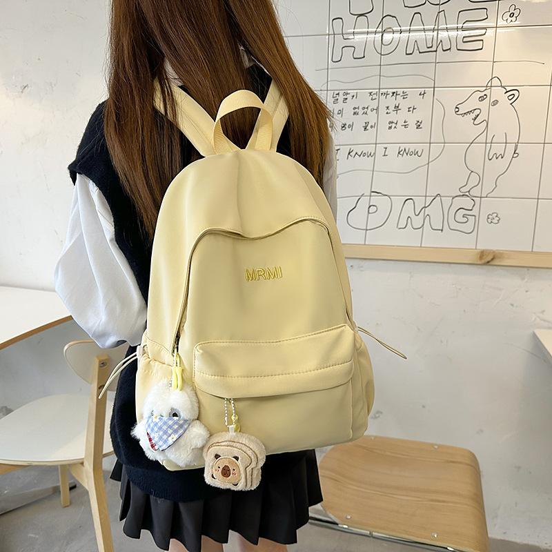 Cream school bag for female junior high school students, high-value niche computer travel backpack, simple and versatile college student backpack