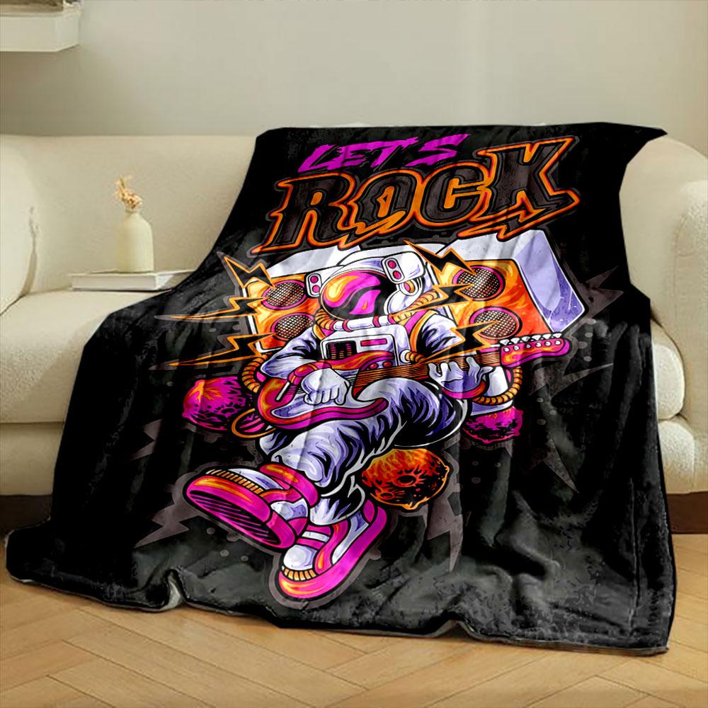 Astronaut playing electric guitar with vibrant cosmic and speaker elements. for all seasons blanket lunch break throw gift