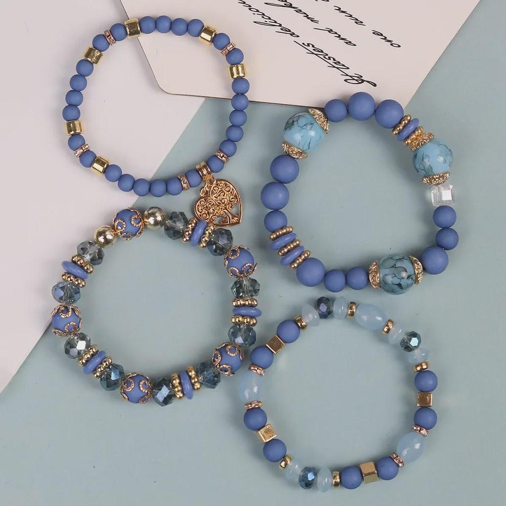 Bohemian Multi-Layer Tassel Bracelet Set with Hollow Heart Pendants and Glass Beads.