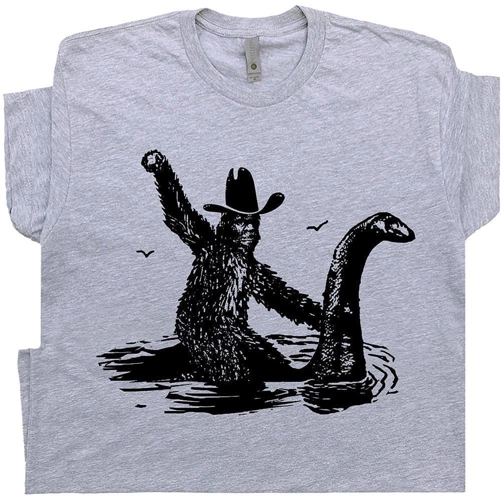 Funny Bigfoot T Shirt Cool Loch Ness Monster Shirt Cool Big Foot Tshirt for Men Women Boys Riding Nessie Cryptid Shirt Sasquatch Graphic Tee