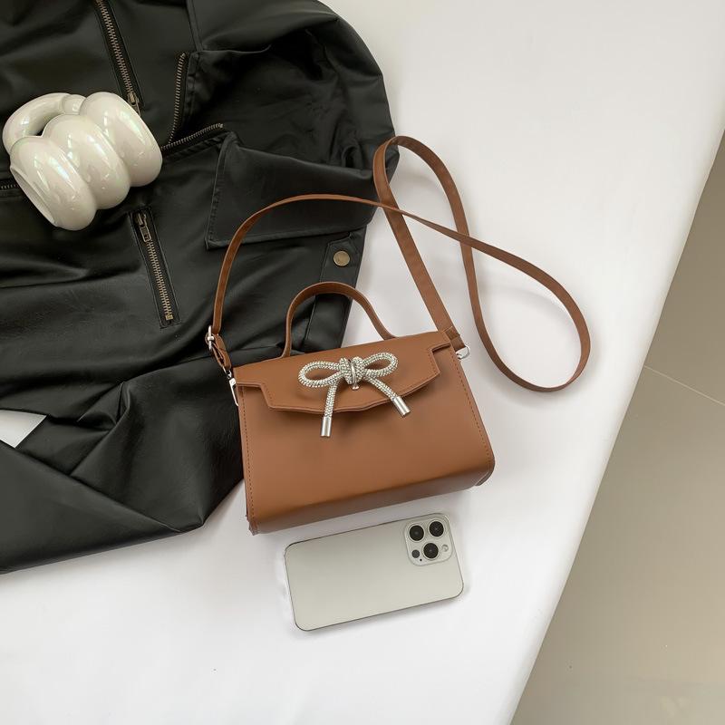 

ins niche French textured bag women s 2025 spring and summer new bow small square bag foreign style shoulder messenger bag коричневий