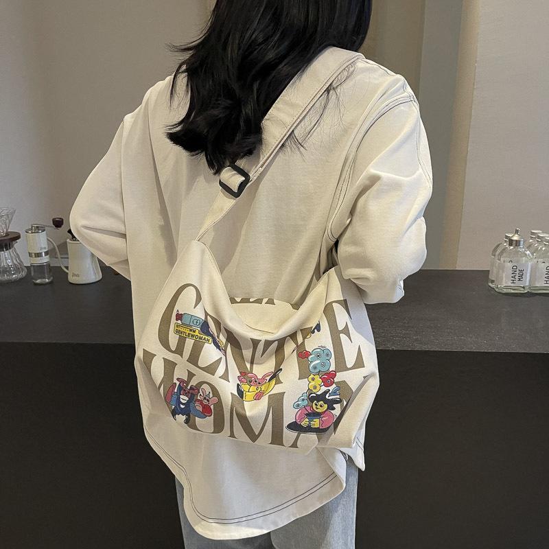 Alphabet canvas bag women's large capacity 2025 new casual handheld cloth bag student class shoulder bag leisure bag