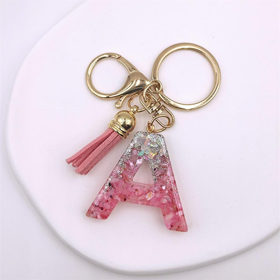 

Кришталевий епоксидний брелок з літерою та китицею - Стильний аксесуар для сумок та автомобілів