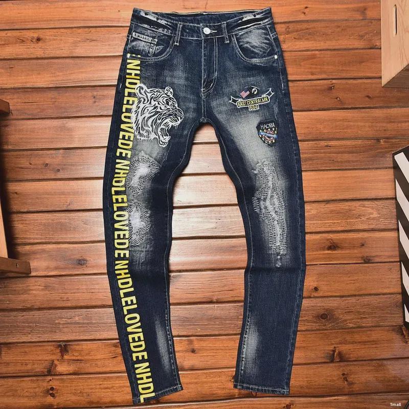 Men's Slim-Fit Embroidered Floral Distressed Jeans with Patches and Elastic Trim.