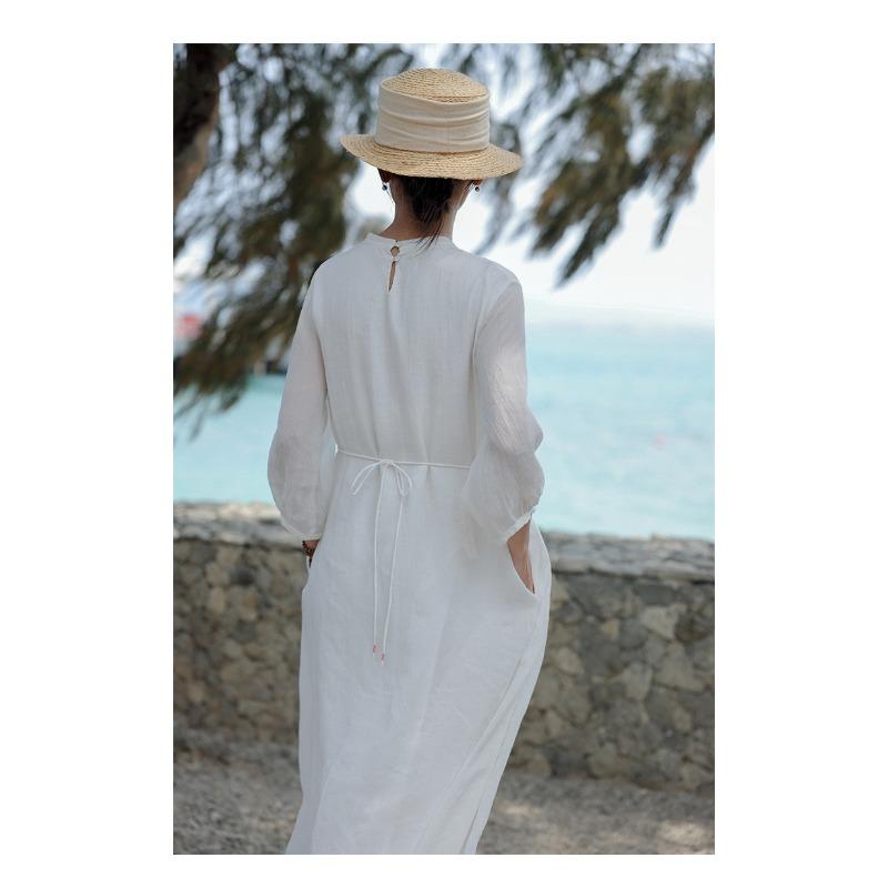 A Woman In A Double Layered Mid Length White Dress