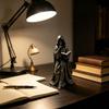 Tabletop Resin Sculpture with Hooded Character, Open Spell Book, and Bronze Style Finish for Shelf Display Use