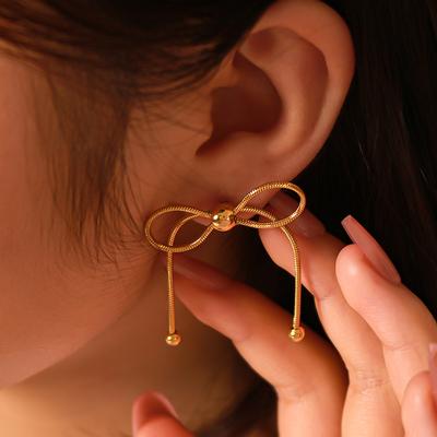 Edelstahl Knochen Schleife Ohrringe für Frauen Goldfarben Hängeohrstecker