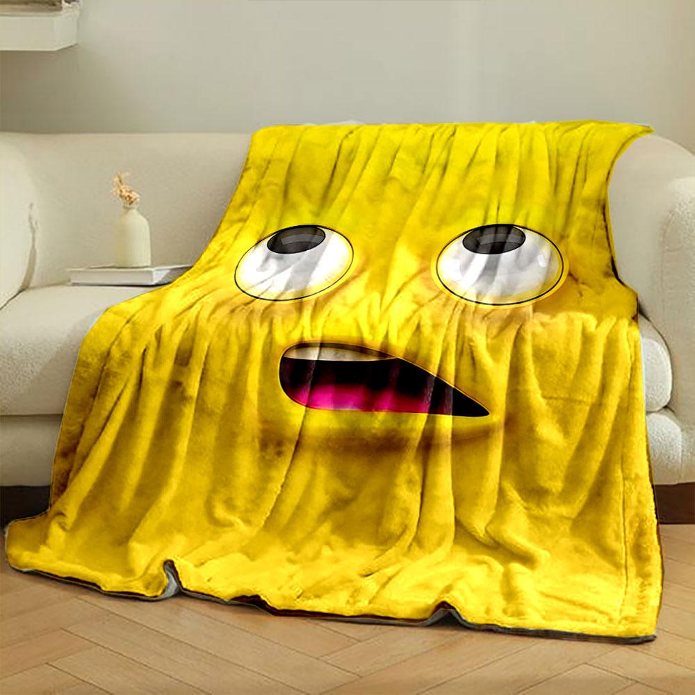 Bright yellow cartoon face with large eyes and an open mouth showing pink. for all seasons blanket lunch break throw gift