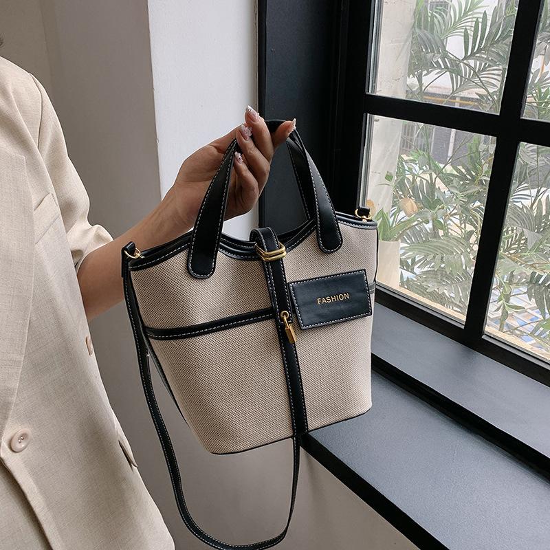 Canvas niche contrasting color handbag women's 2025 summer new Korean fashion shoulder messenger bag versatile bucket bag