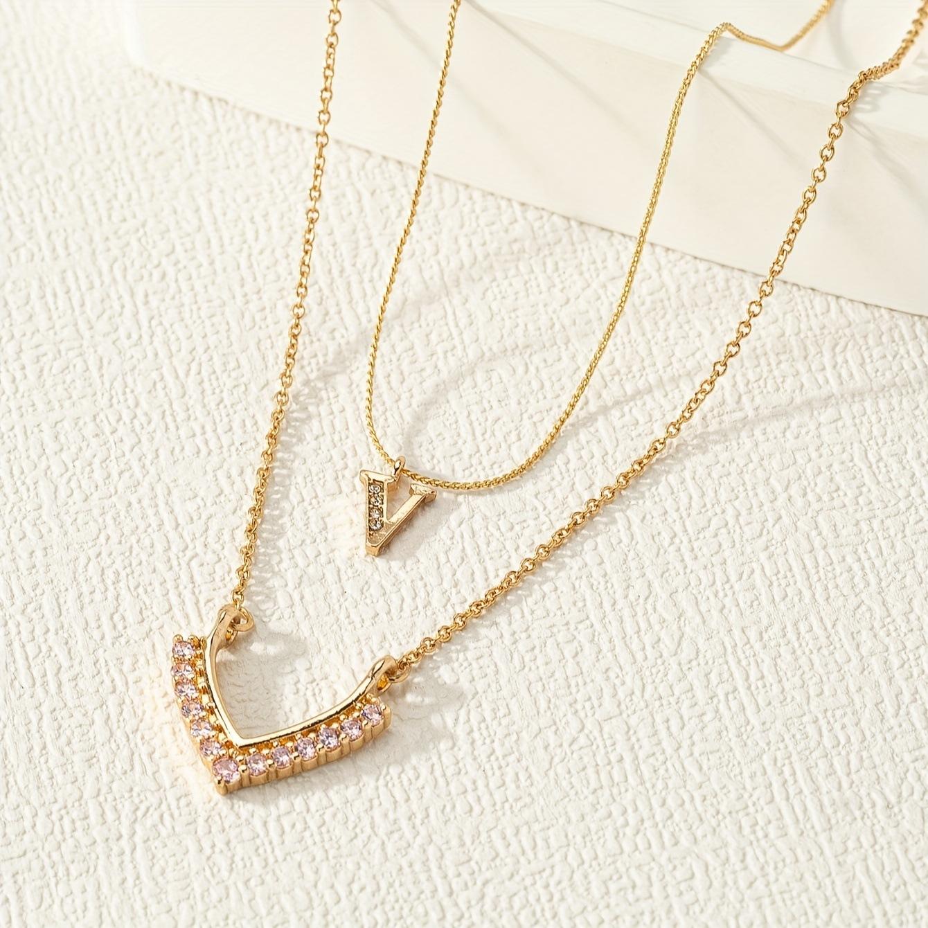 

A double-layered necklace with a golden yellow chain set with rhinestones is fashionable, light and luxurious