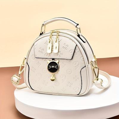 Umhängetasche mit geometrischer Prägung, kleine Handtasche mit Farbkontrasten, süße Schultertasche mit Katzenkuppel