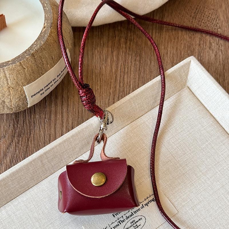 Retro Leather Coin & Earphone Pouch Necklace - Versatile Commuting Sweater Chain, High-End Jewelry.