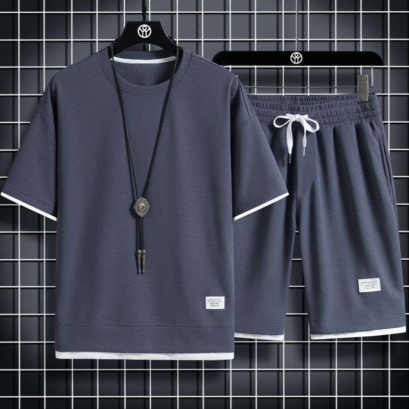 Letni męski dwuczęściowy zestaw tkanina lniana luźna koszulka i zestaw szortów męski strój sportowy moda dres z krótkim rękawem garnitury męskie