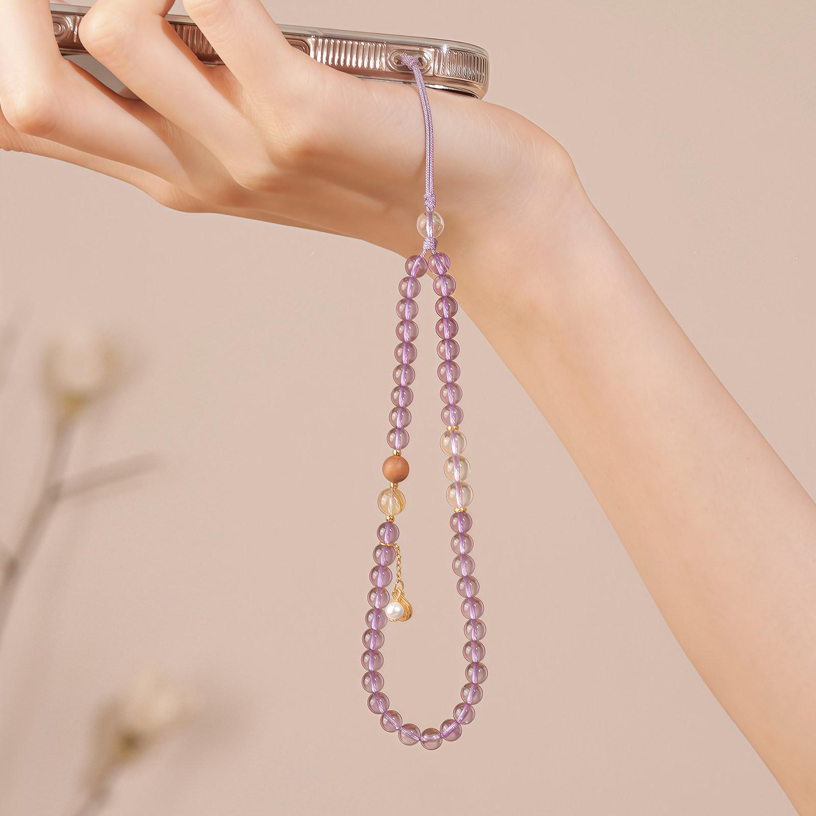

The Fortune Star Chain is a natural purple-white crystal, golden rutilated quartz, and pearl phone chain that attracts wealth, offering a light Amethyst and white crysta