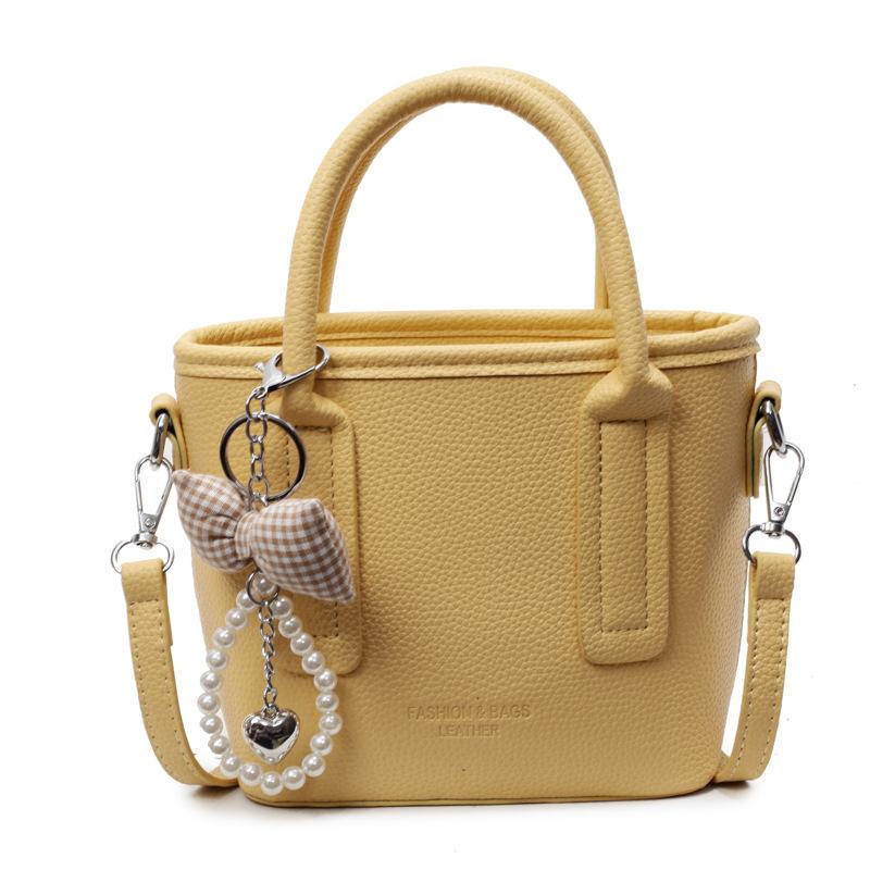 Spring and summer popular solid color simple high quality lychee pattern portable bucket bag women's fashion versatile commuter messenger bag
