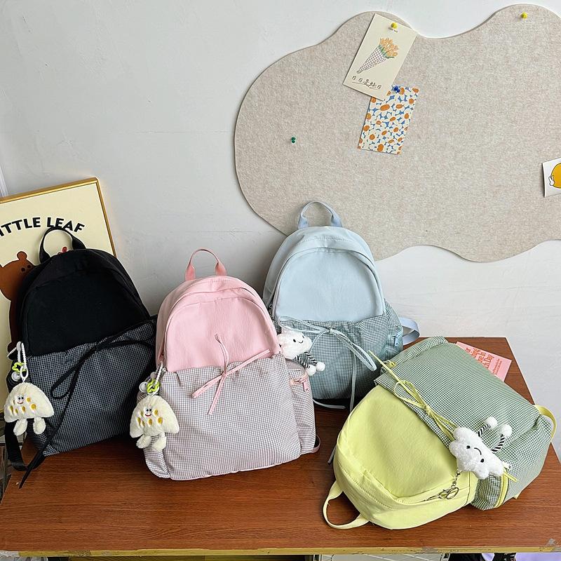 High-value bow ins niche plaid schoolbag for female junior high school students, casual and lightweight college students, travel backpack.