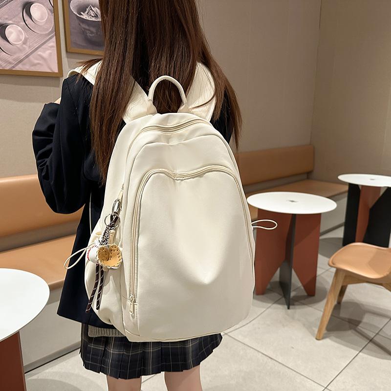 Casual solid color large-capacity schoolbag 2025 new versatile junior high school backpack college student travel backpack tide