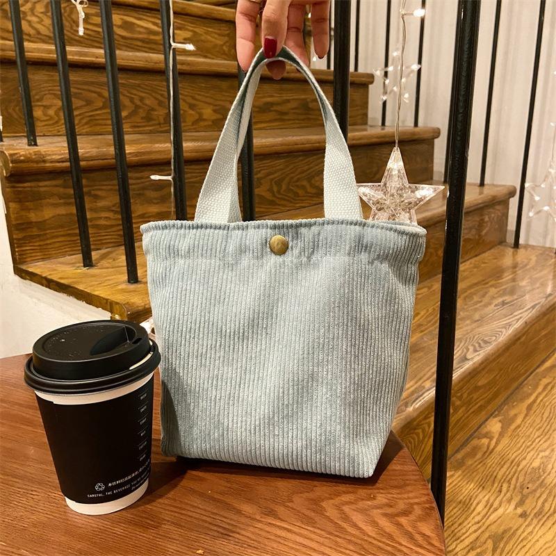 [Spot] Literary and artistic corduroy bag portable casual women's small hand bag retro cloth bag bento bag