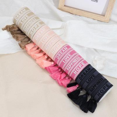 European & American Embroidered Friendship Bracelet: Handmade Woven Tassel with Logo Lettering.