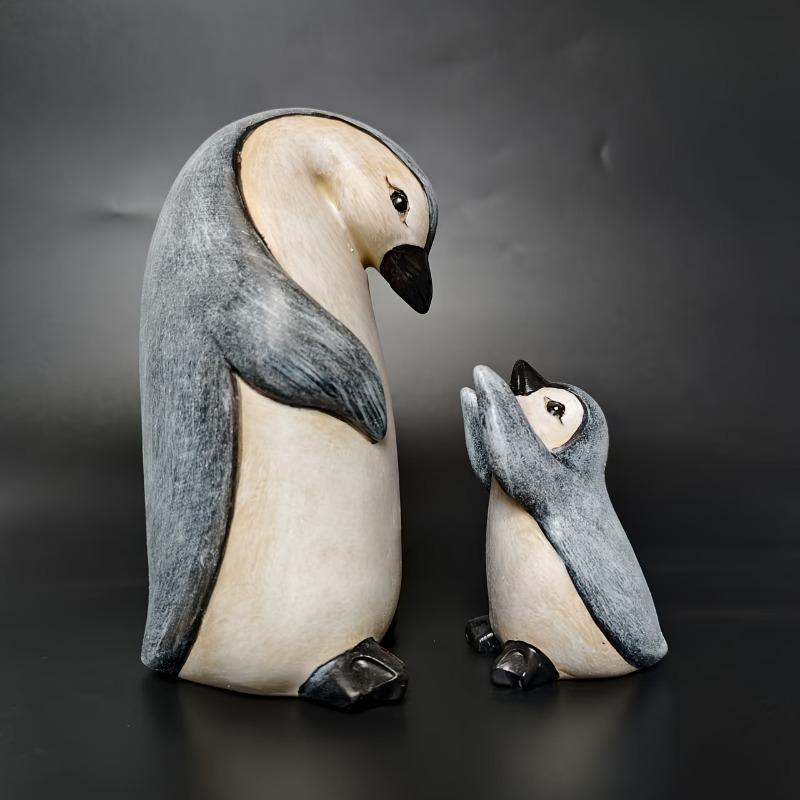 A Set of Two Resin Statues Featuring a Mother And Penguin Showcasing a Creative Family Theme These Can Serve As Decorative Pieces for Home
