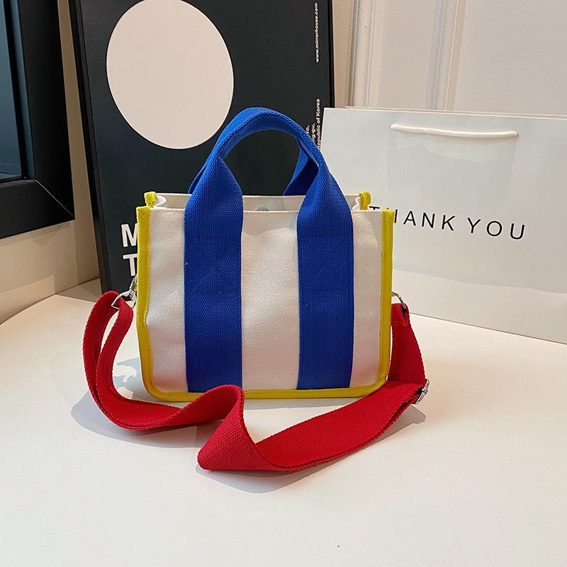 2025 fashion new women's bag niche design color matching canvas bag foreign style portable magnetic buckle bag versatile shoulder bag tide