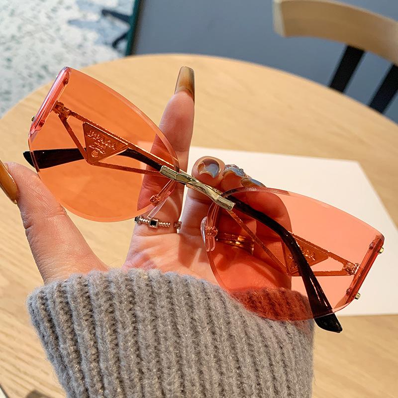 European and American new street photography frameless sunglasses women's hollow metal frames advanced cat glasses sunscreen sunglasses