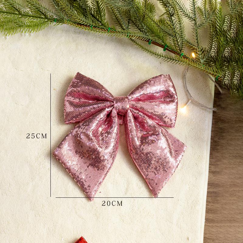 Große rosa und goldglitzernde Weihnachtsbaumschleife