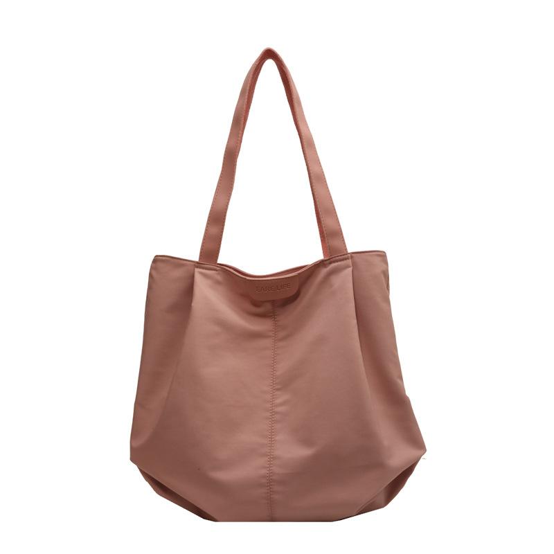 

Large capacity women s bag new 2025 fashion simple commuter shoulder bag casual solid color cloth bag tote bag рожевий